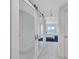 Hallway view with a sliding mirrored closet door looking into the main bedroom at 2450 Harbourside Dr # 233, Longboat Key, FL 34228