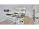 Kitchen with breakfast bar, stainless appliances, and custom cabinetry, offers modern convenience at 2450 Harbourside Dr # 233, Longboat Key, FL 34228