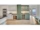 Kitchen featuring modern appliances, custom cabinets, and adjacent wine storage at 2450 Harbourside Dr # 233, Longboat Key, FL 34228