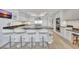 Eat-in kitchen featuring modern fixtures, stone countertops, and stainless steel appliances at 2450 Harbourside Dr # 233, Longboat Key, FL 34228