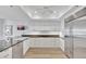 Well-lit kitchen with stainless steel appliances, stone countertops, and bright white cabinets at 2450 Harbourside Dr # 233, Longboat Key, FL 34228