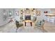 Cozy living room with fireplace, built-in shelving, and view of kitchen at 2450 Harbourside Dr # 233, Longboat Key, FL 34228