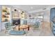 Comfortable living room featuring a fireplace, built-ins, and a view of the kitchen at 2450 Harbourside Dr # 233, Longboat Key, FL 34228