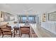Bright living room boasting a ceiling fan, hardwood floors, modern furniture, and ocean views at 2450 Harbourside Dr # 233, Longboat Key, FL 34228