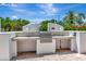 Outdoor kitchen with grill and counter space at 2450 Harbourside Dr # 233, Longboat Key, FL 34228