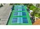 Overhead shot of community pickleball courts, surrounded by tropical landscaping and a convenient parking area at 2450 Harbourside Dr # 233, Longboat Key, FL 34228