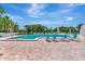 Beautiful outdoor swimming pool with lounge chairs and lush tropical landscaping, perfect for relaxation at 2450 Harbourside Dr # 233, Longboat Key, FL 34228