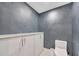 Contemporary powder room with modern toilet, white vanity and gray walls at 2450 Harbourside Dr # 233, Longboat Key, FL 34228