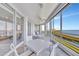 The tiled sunroom offers plenty of space for relaxing and enjoying the beautiful water views at 2450 Harbourside Dr # 233, Longboat Key, FL 34228