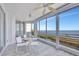This sunroom has tile floors, floor to ceiling windows, and furniture with gorgeous water views at 2450 Harbourside Dr # 233, Longboat Key, FL 34228