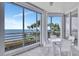 Bright sunroom features tile floors, floor to ceiling windows, and beautiful water views at 2450 Harbourside Dr # 233, Longboat Key, FL 34228