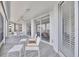 The sunroom includes tiled floors, lots of windows, and comfortable seating for enjoying the view at 2450 Harbourside Dr # 233, Longboat Key, FL 34228