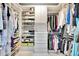 Organized walk-in closet with shelving, drawers, and hanging rods for optimal storage at 2450 Harbourside Dr # 233, Longboat Key, FL 34228