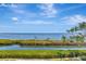 A beautiful water view on a clear day with grassy land and green trees at 2450 Harbourside Dr # 233, Longboat Key, FL 34228
