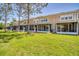 Backyard view showcasing multiple screened patios and lush green space in a community setting at 2819 Conch Hollow Dr, Brandon, FL 33511