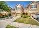 Inviting townhouse with attached garages, neutral stucco, red shutters and well-maintained landscaping at 2819 Conch Hollow Dr, Brandon, FL 33511