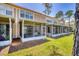 Rear exterior view of condo with multiple screened porches and lush green lawn at 2819 Conch Hollow Dr, Brandon, FL 33511