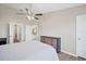 Spacious primary bedroom with hardwood floors, dresser, ceiling fan and attached bath at 2819 Conch Hollow Dr, Brandon, FL 33511