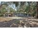 Charming home with a covered patio, ample parking, and a spacious yard, surrounded by trees at 2848 Trinidad St, Sarasota, FL 34231