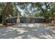 Charming single-story home features a large front yard and eye-catching blue exterior door at 2848 Trinidad St, Sarasota, FL 34231