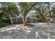 Charming single-story home features a large front yard and eye-catching blue exterior door at 2848 Trinidad St, Sarasota, FL 34231