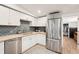 Modern kitchen featuring stainless steel appliances, light countertops, and a classic tile backsplash at 2848 Trinidad St, Sarasota, FL 34231