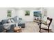 Cozy living room with wood floors, comfortable seating, and a serene view outside the window at 2848 Trinidad St, Sarasota, FL 34231
