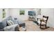 Cozy living room with wood floors, comfortable seating, and a serene view outside the window at 2848 Trinidad St, Sarasota, FL 34231