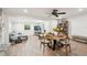 Open floor plan showcasing a living room and dining area with wood-look floors and plenty of natural light at 2848 Trinidad St, Sarasota, FL 34231