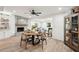 Open floor plan showcasing a dining area and fireplace with wood-look floors and plenty of natural light at 2848 Trinidad St, Sarasota, FL 34231