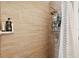 Tiled shower with adjustable shower head and wall-mounted caddy at 2848 Trinidad St, Sarasota, FL 34231