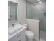 The modern bathroom has light gray walls, a glass shower, and a vessel sink with chrome fixtures at 306 Island Cir, Sarasota, FL 34242