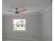 Bedroom features ceiling fan, window, and neutral-toned walls at 306 Island Cir, Sarasota, FL 34242