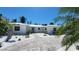 Charming single-story home featuring a lush, landscaped front yard and a brightly colored front door at 306 Island Cir, Sarasota, FL 34242