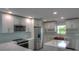 This kitchen has bright white cabinets, stainless steel appliances, a backsplash, and marble countertops at 306 Island Cir, Sarasota, FL 34242