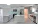 Bright modern kitchen boasts white cabinets, stainless steel appliances, a center island, and marble countertops at 306 Island Cir, Sarasota, FL 34242