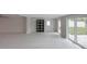 Open living room features recessed lighting, light grey paint, modern fixtures, and sliding glass doors at 306 Island Cir, Sarasota, FL 34242