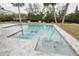 Outdoor in-ground swimming pool and spa area with custom tile and canal views at 306 Island Cir, Sarasota, FL 34242