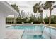 Beautiful in-ground pool and jacuzzi with waterfront views off the back porch at 306 Island Cir, Sarasota, FL 34242