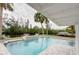 Outdoor in-ground swimming pool and spa overlook a canal at 306 Island Cir, Sarasota, FL 34242