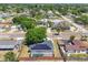 Aerial view of a neighborhood featuring a home with solar panels and screened pool at 3136 Webber St, Sarasota, FL 34239