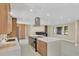 Open concept kitchen boasts a large island with cooktop, stainless hood, and a spacious layout for entertaining at 3136 Webber St, Sarasota, FL 34239