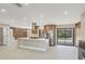 Open-concept kitchen boasting a large island, stainless steel appliances, and seamless access to the outdoor pool area at 3136 Webber St, Sarasota, FL 34239