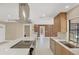View of open kitchen featuring quartz counters, stainless appliances, and a seamless flow to the outdoor pool area at 3136 Webber St, Sarasota, FL 34239