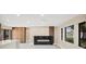 Open living room with fireplace, wood accents, and an island with storage at 3136 Webber St, Sarasota, FL 34239