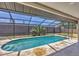 Inviting screened-in pool features a sunny deck at 3136 Webber St, Sarasota, FL 34239