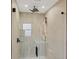 Walk-in shower with glass enclosure, rainfall shower head and shower shelf at 3136 Webber St, Sarasota, FL 34239