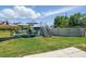 Lawn with a pool, patio set, and umbrellas offers an outdoor relaxation spot at 3260 Pinetree St, Port Charlotte, FL 33952
