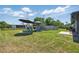 Spacious backyard features a pool, patio furniture, and well-maintained lawn at 3260 Pinetree St, Port Charlotte, FL 33952