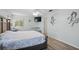 Bedroom features a large bed with a white and blue floral patterned comforter, and wood floors at 3260 Pinetree St, Port Charlotte, FL 33952